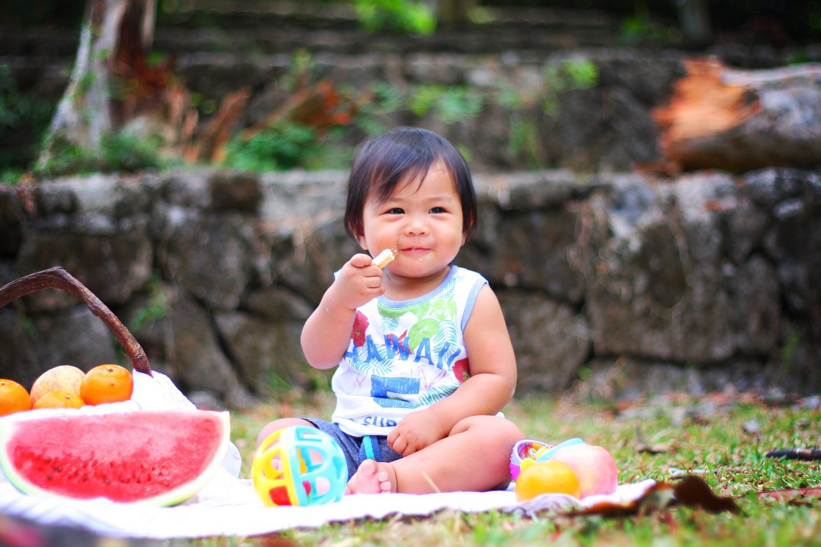 Bebé comiendo frutas en el parque